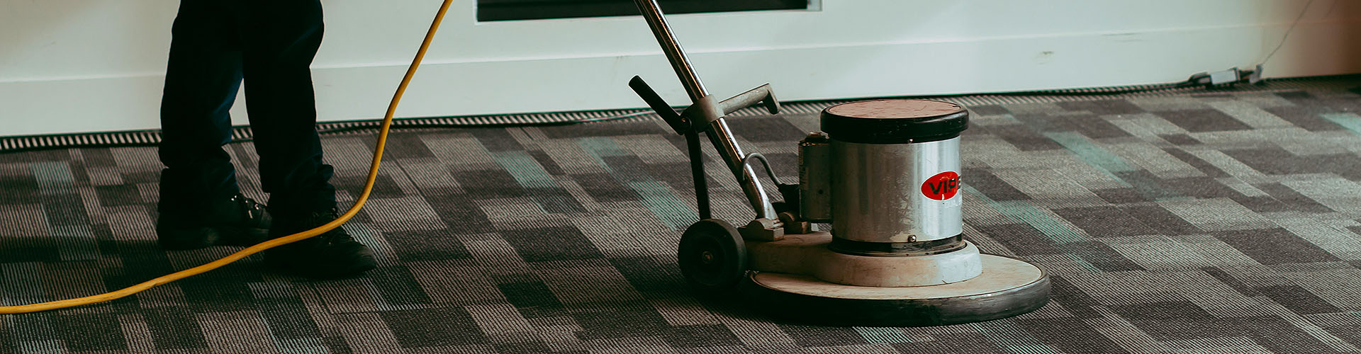 Swept space cleaning crew cleaning carpet flooring in Victoria office