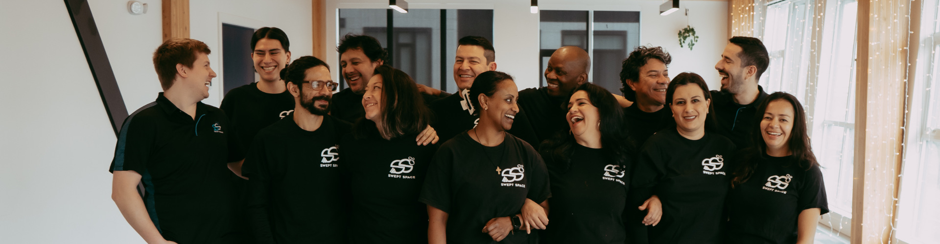 Professional cleaning team of Swept Space smiling and laughing together